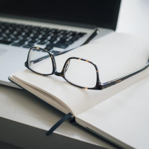 Notes on a desktop to find customers with the video