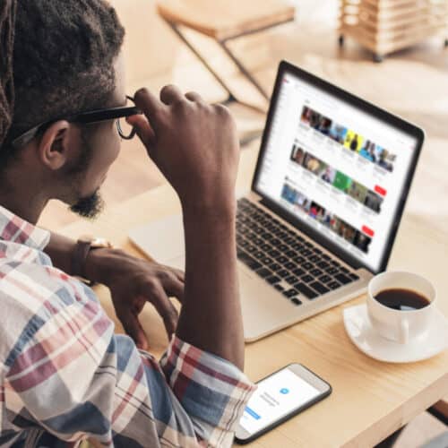 african american man creating laptop with youtube website and